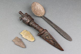 A wooden spoon together with a carved wooden sculpture and 2 arrowheads 