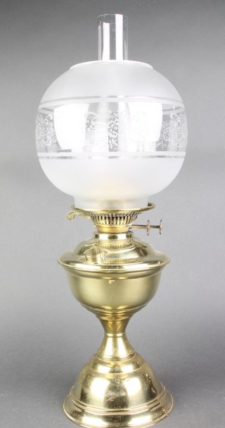 A brass oil lamp with clear glass chimney and opaque glass shade (slight dent) 