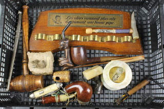 A pipe rack together with a folding pocket knife and various pipes 