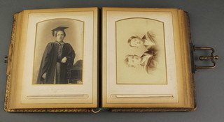 A Victorian leather bound family photograph album and contents of black and white portrait photographs