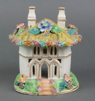A 19th Century Staffordshire pastel burner in the form of a thatched cottage raised on an oval base 6"h 