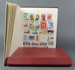 A red album of mint and used world stamps - Hong Kong, Jamaica and a black album of stamps Bahrain, Bolivia 