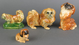A Royal Doulton figure of a seated Pekingese, base marked KGB 2", a Chinese pottery figure of a Pekingese 2", a ditto Continental porcelain figure 5" and a ditto Beswick figure 4" 