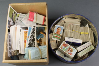 A metal biscuit tin containing a collection of cigarette cards and a collection of tea cards etc 