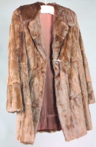 A lady's quarter length brown fur coat 