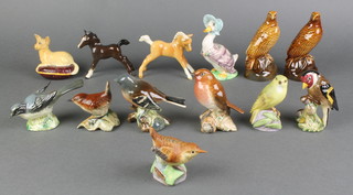 4 Beswick figures of birds - Chaffinch 991, Wren 883, Robin 980, Goldfinch 2273 and 1 other marked Beswick all 3", a Beswick figure of a Palomino foal 3" (chip to ear), Beswick figure of Jemima Puddleduck, Beswick figure of a seated Pekingese on cushion, 2 Beneagles Beswick Scots Whisky bottles in the form of eagles 5", brown glazed figure of a foal 3", 2 Royal Worcester figures of birds - Wren 3198, Wood Warbler 3200 3" 
