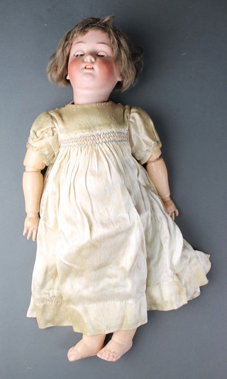 A 19th Century Simon and Halbig  German porcelain headed doll with open and shutting eyes, open mouth with teeth and articulated limbs