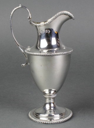 A Victorian silver Adam style cream jug with beaded decoration and gilt interior, London 1871 6 .25" 