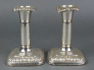 A pair Edwardian of repousse silver dwarf candlesticks with gadroon decoration, Birmingham 1907, 5.25" 
