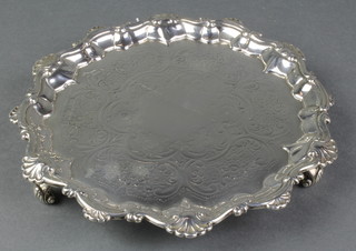 A William IV silver card tray with Chippendale and scroll rim with chased floral decoration and vacant cartouche on scroll feet, London 1831, 7 1/2" 