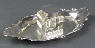 An Edwardian silver quatrefoil ink stand with glass inkwell and silver lid, Chester 1905 