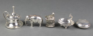 An Edwardian silver novelty pin cushion in the form of a standing elephant, Birmingham 1906, a ditto table lamp, a shell shaped salt, a circular snuff box and a plated snuff box in the form of a bears head 