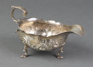 A good George II repousse silver sauce boat with S scroll handle and hoof feet, the later decoration with flowers, London 1753, 115 grams