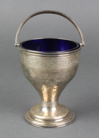 A George III waisted silver swing handled basket, now with blue glass liner, London 1802, 103 grams