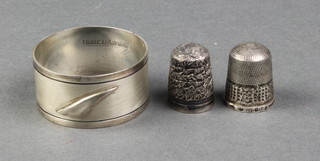 A silver napkin ring, a ditto thimble and a silver plated thimble, 21 grams