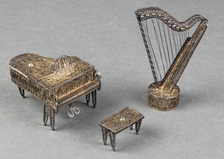 A Continental silver filigree miniature of a grand piano and stool and a ditto of a harp 