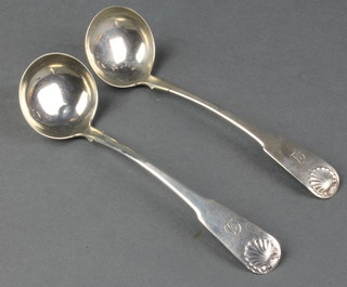 A pair of Georgian silver sauce ladles with shell terminals 