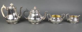 A Victorian 4 piece silver tea and coffee set of bulbous ribbed form with ebony and ivory mounts, London 1844/1845, Garrards, gross 52 ozs 