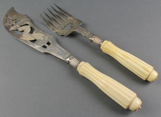 A pair of Edwardian silver plated chased and pierced fish servers with fancy ivory handles 