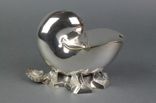 An Edwardian silver plated spoon warmer in the shape of a shell on a rocky base 