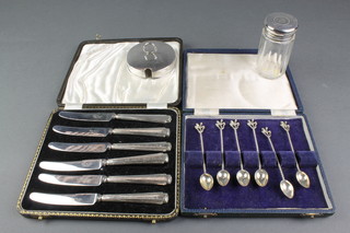 A silver mounted toilet jar London 1913, a silver preserve pot lid, a cased set of foreign silver coffee spoons and 6 cased silver handled butter knives 