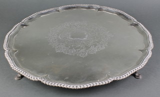 A George III silver salver with egg and dart rim and chased scroll decoration on hoof feet London 1764 17", 53  ozs 
