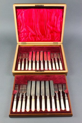 A set of silver plated dessert eaters with carved mother of pearl handles for 12, in a fitted walnut canteen 