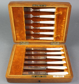 A cased set of 6 silver handled fruit knives and forks with mother of pearl handles Sheffield 1914 