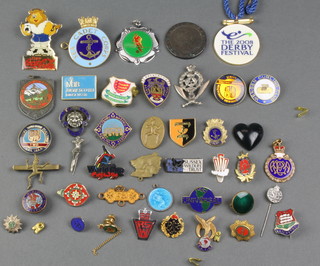 A collection of enamelled lapel Badges and pins 