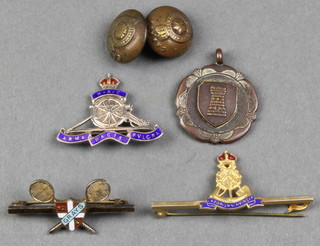 A silver and enamelled Royal Artillery lapel badge and minor badges