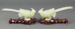 A pair of carved Chinese green hardstone carved figures of standing birds 6" on hardwood stands 