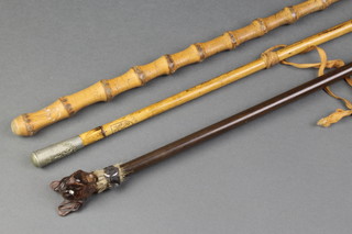 A Brighton College swagger stick, a bamboo cane and a cane with a French bulldog handle with articulated jaw 