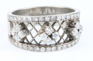 A white gold diamond set open trellis ring, with  34 brilliant cut stones enclosing 12 brilliant cut stones, size Q 