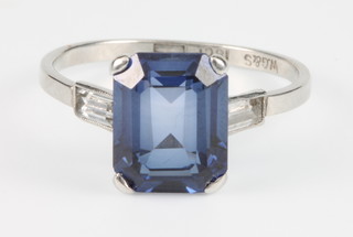 An 18ct white gold synthetic blue sapphire and baguette diamond dress ring, size O 1/2