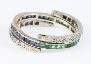 A gem set white gold flip over ring, set with 2 half bands of diamonds, a half band of emeralds and a half band of sapphires, size Q 1/2