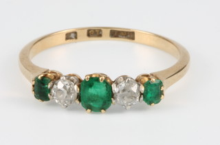 An 18ct yellow gold emerald and diamond 5 stone ring, size L 