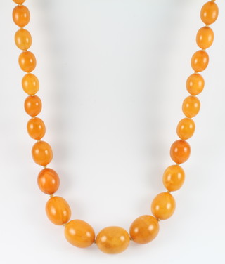 A string of oval butterscotch amber beads, the largest 22mm long x 20mm deep, the smallest 7mm long x 5mm deep, gross 65 .4 grams