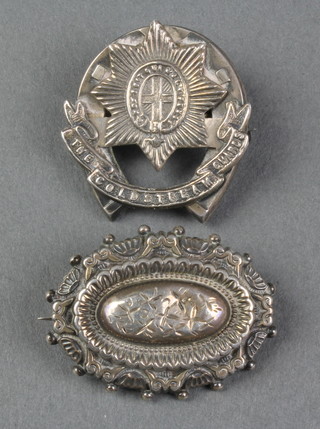 A Victorian silver repousse brooch and 1 other 