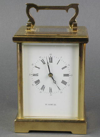 H Samuels, a 20th Century striking carriage clock with enamelled dial and Roman numerals contained in a gilt metal case 5"h