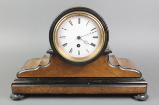 A 19th Century French 8 day timepiece with enamelled dial and Roman numerals contained in a figured walnut drum shaped case, raised on bun feet