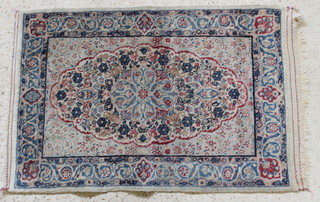 A Persian Kirman white and blue ground rug with diamond to the centre 37" x 24" 