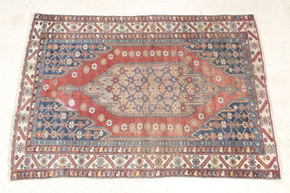 A Mazleghan  brown and blue ground with diamond medallion to the centre 76" x 55", some wear 