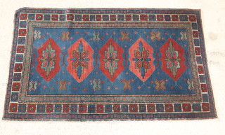 A blue ground Persian rug with 5 diamonds to the centre 61" x 39" 