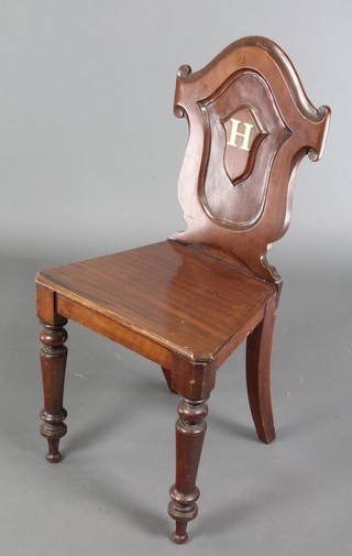 A Victorian mahogany hall chair with solid seat, raised on turned supports (old repair to back leg)