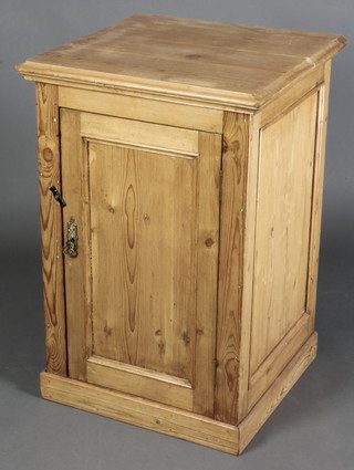 A Victorian pine enclosed wash stand with hinged lid, the interior fitted and enamelled bowl, the base enclosed by a panelled door, raised on a platform base 33"h x 22"w x 21"d  