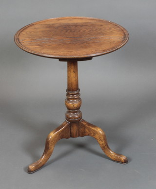 A 19th Century style turned oak wine table with dish top, raised on pillar and tripod base 27"h x 22" diam. 