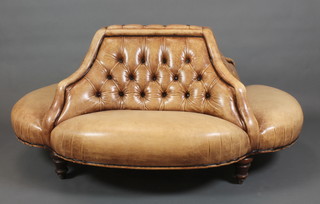 A Victorian style Conversation Seat, upholstered in brown buttoned leather, raised on turned supports,  34"h x 58"w x 45"d 
