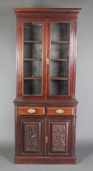 A late Victorian mahogany mahogany bookcase on cabinet, the upper section fitted a moulded cornice the interior fitted adjustable shelves enclosed by glazed panelled doors, the base fitted 2 long drawers above a double cupboard, raised on a platform base 86"h x 34"w x 17"d 