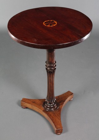 A circular William IV mahogany wine table, the top inlaid a rosette and raised on turned and fluted column with triform base ending in bun feet, 30"h x 20" diam. (made up)