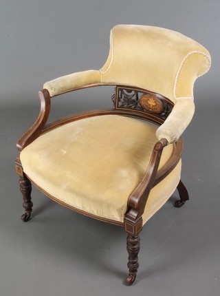 An Edwardian inlaid mahogany tub back chair upholstered in yellow Dralon and raised on turned supports 